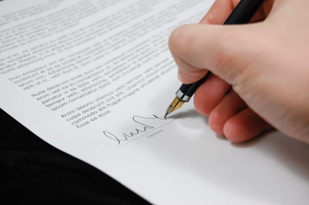 Person Signing an Ethical Web Design Contract